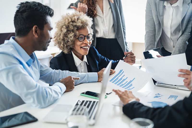 Group of business professionals working together around a table