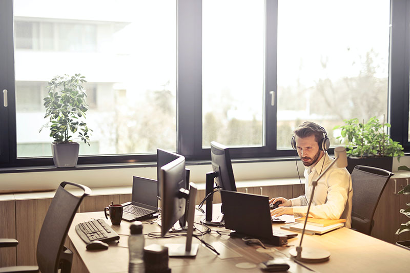 Businessman working at his desk with headset on